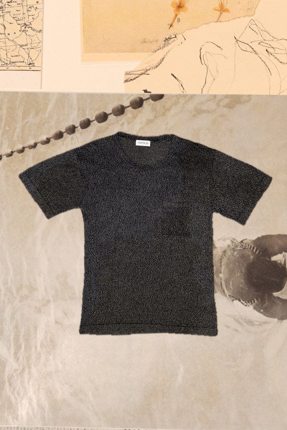A black textured short-sleeve T-shirt with a crew neckline, featuring a soft, plush material and a subtle pocket detail.