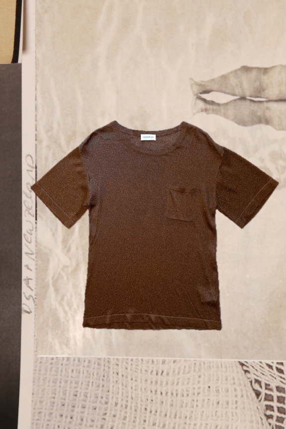 Brown short-sleeve pocket t-shirt in a fitted style with a subtle shimmer, laid on a textured neutral background.