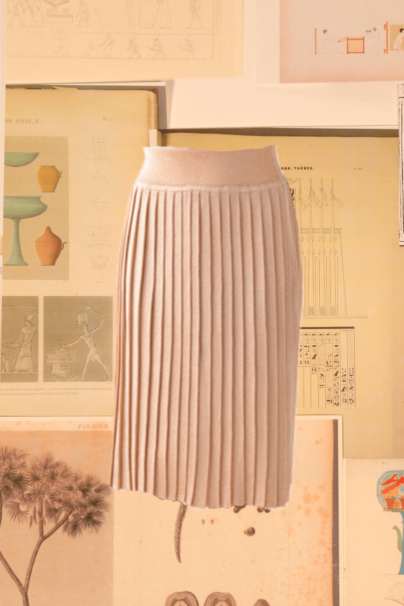 A beige pleated skirt displayed against a backdrop of vintage illustrations and diagrams.