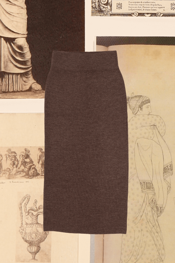 A brown, high-waisted, fitted knit skirt set against a backdrop of vintage artwork.