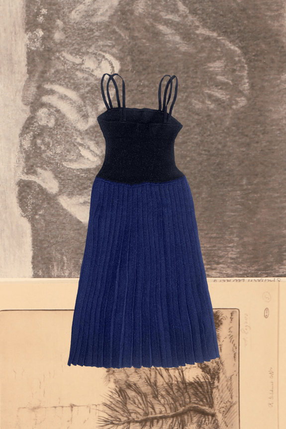 A black spaghetti strap top with a fitted waist flows into a pleated navy skirt, set against a textured, artistic background.