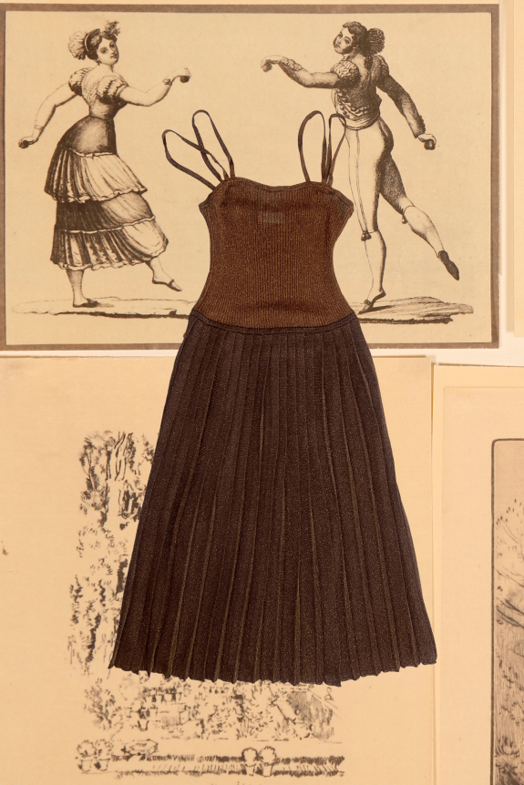 A brown pleated knit midi dress with spaghetti straps, set against vintage-style illustrations.