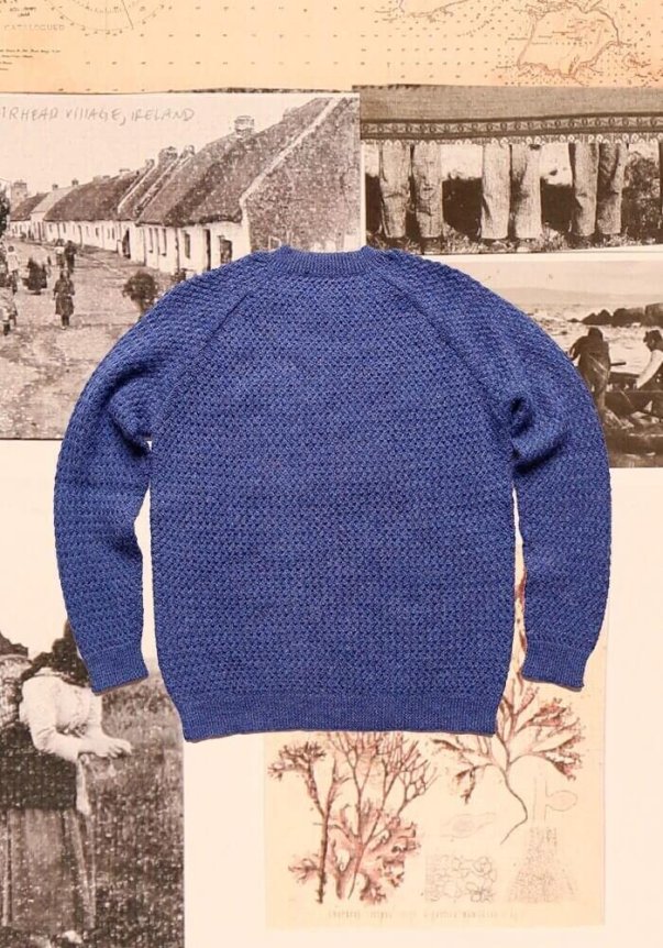 A blue textured knit sweater with a relaxed fit is displayed against a backdrop of vintage Irish village images and natural illustrations.