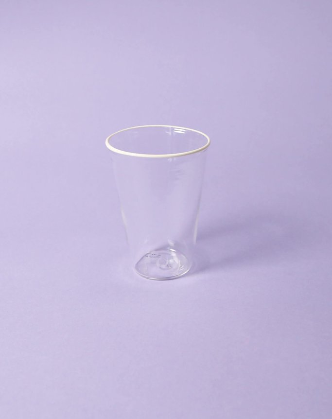 A transparent plastic cup is placed on a purple background.