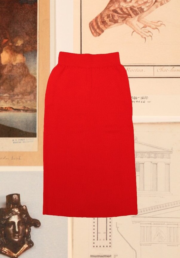 A vibrant red, ribbed knit pencil skirt with a high-waisted fit, displayed against a backdrop of historical artwork and architectural sketches.