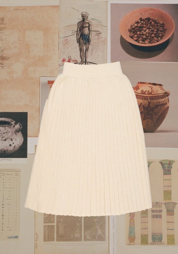 A cream-colored, ribbed knit skirt with a high-waisted, A-line fit, set against a background of various historical and artistic prints.
