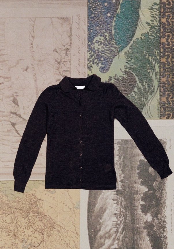 A black, long-sleeve, slim-fit cardigan with a button-down front, set against a background of vintage maps and illustrations.