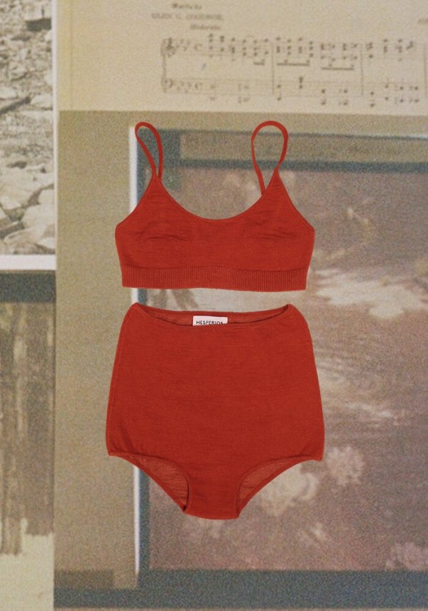 A rust-colored bralette and high-waisted brief set made of soft fabric, featuring a seamless design against a vintage-themed background with sheet music and photographs.