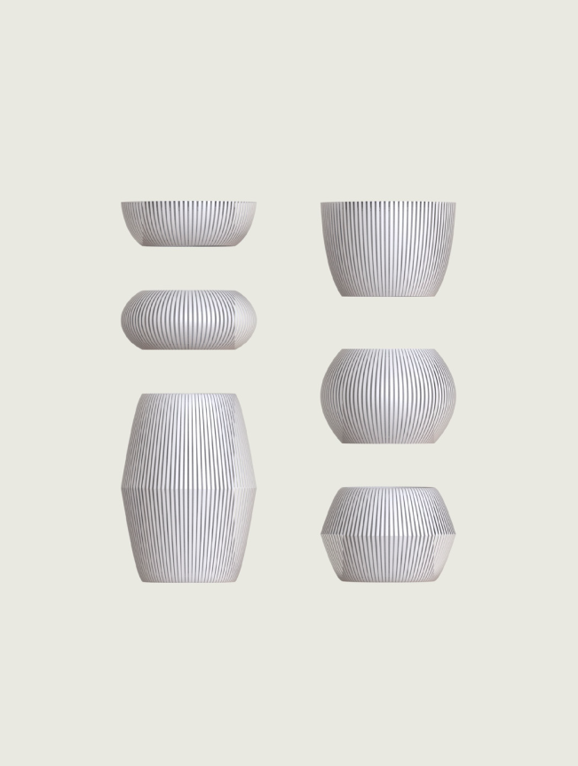 A collection of sleek, gray-striped ceramic vases in various geometric shapes displayed against a plain, light background.