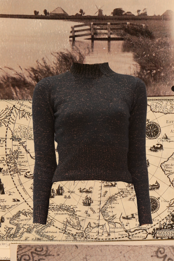 A black sparkly knit sweater with a fitted silhouette and ribbed texture against a vintage map and sepia-toned river landscape background.