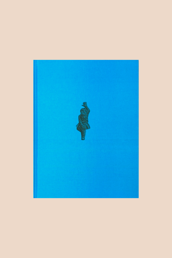 A blue book with a simple, minimalistic cover featuring a small, centered illustration.