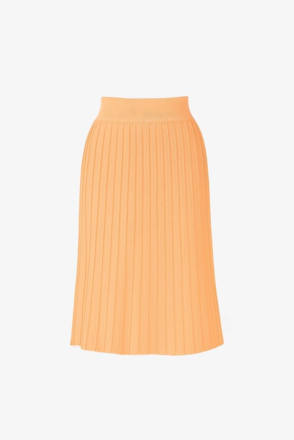 An orange pleated skirt against a plain background.