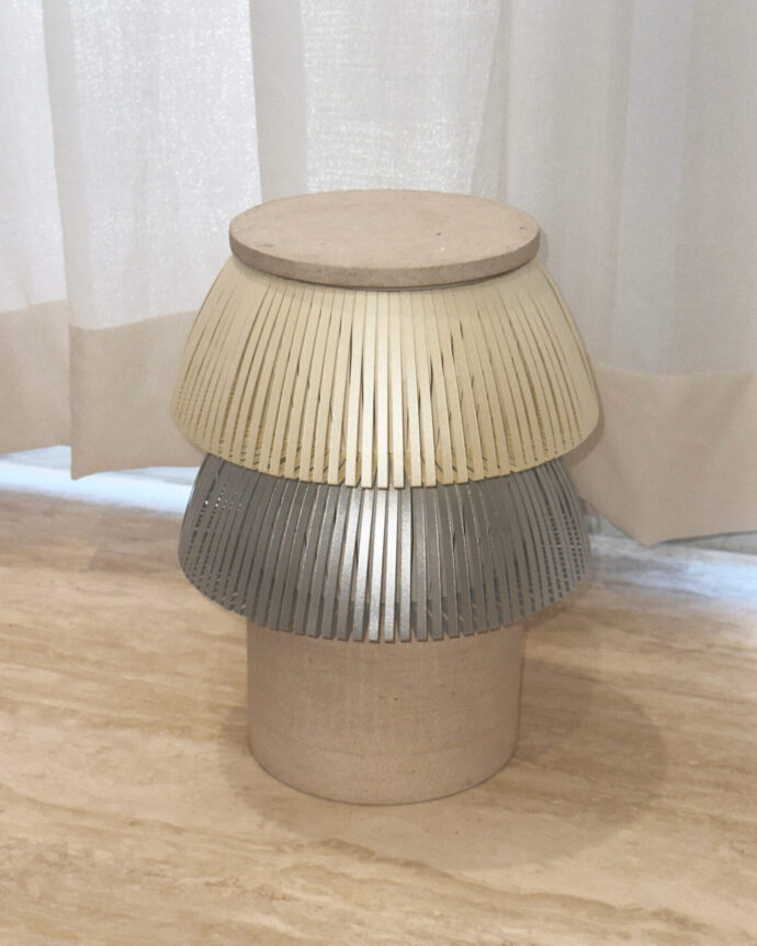 Hesperios modular paper lighting with pleated sculptural table lamp with stone base.