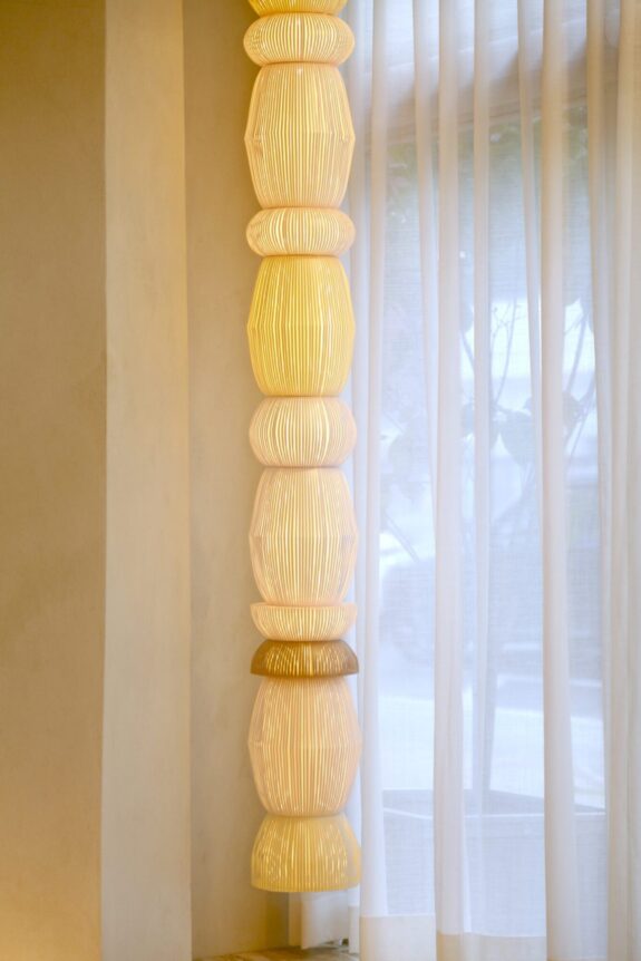 Hesperios modular paper lighting with pleated sculptural shade chain pendant.