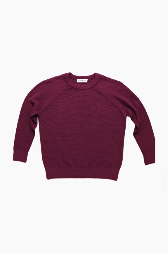 A burgundy sweater with a visible label on a white background.