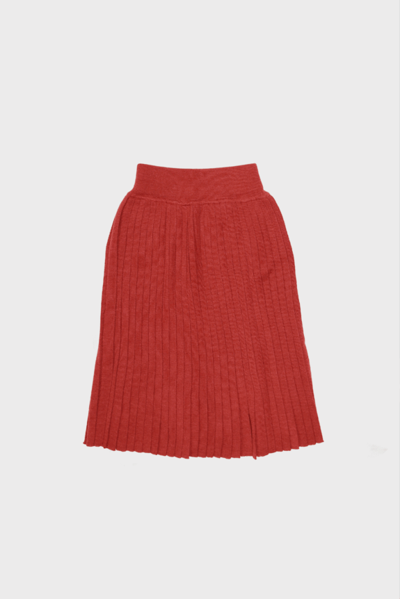 A red pleated skirt laid flat on a white background.