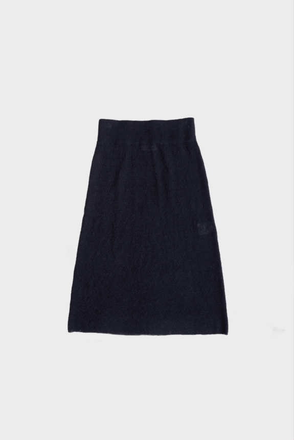 A navy blue knitted skirt on a plain background.