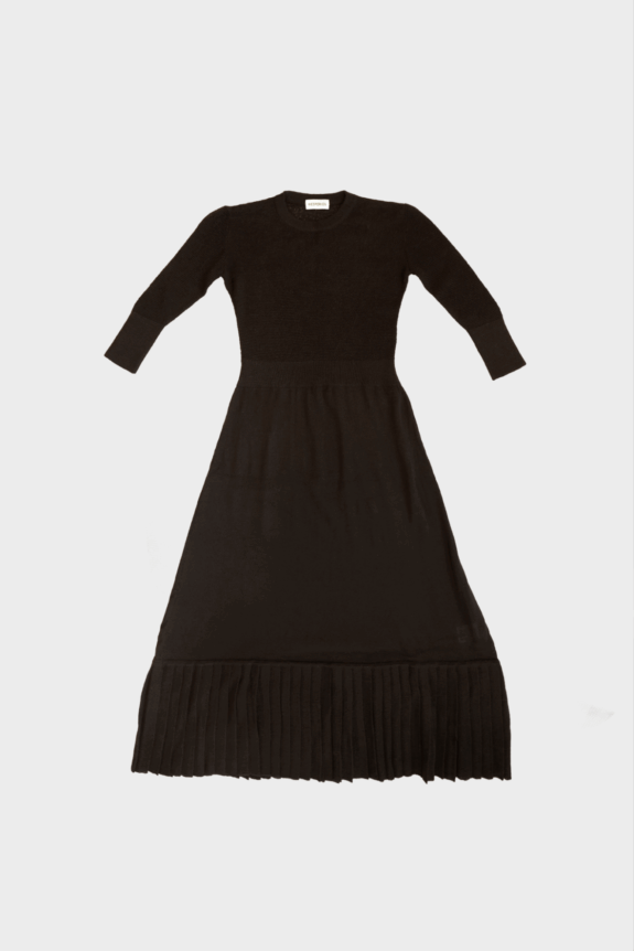 A black, long-sleeve, A-line dress with a pleated hem.