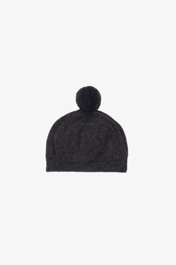 A dark knitted beanie with a pom-pom on top.