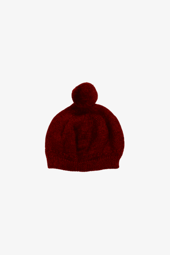 A red knitted beanie with a pom-pom on top.