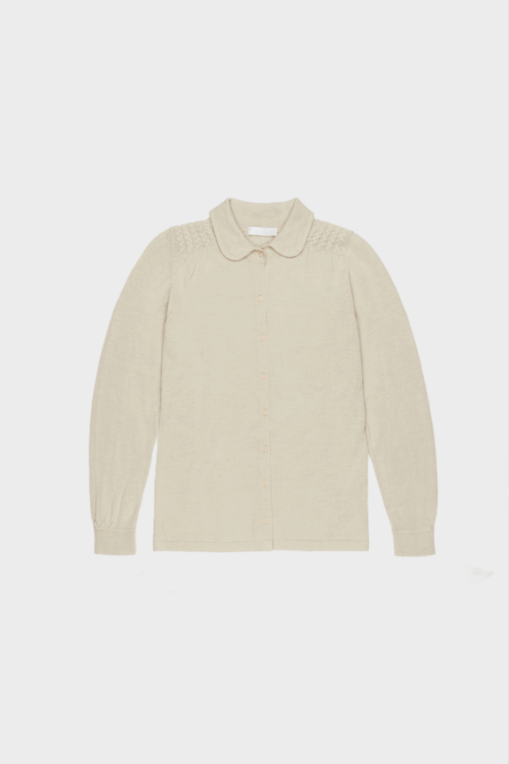 A beige long-sleeve button-up blouse with a Peter Pan collar and textured shoulder detailing.