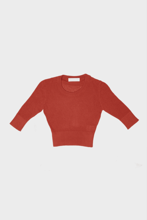 Red cropped sweater with three-quarter sleeves on a plain background.