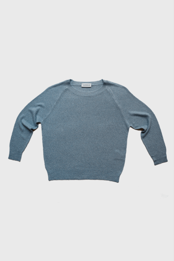 A blue knitted sweater with long sleeves laid out flat against a white background.