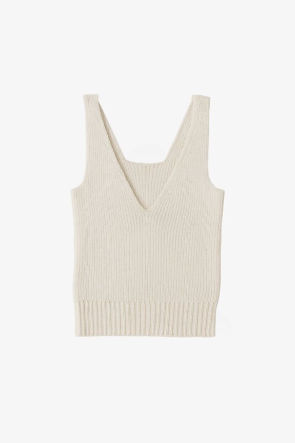 A white knitted sleeveless v-neck top on a plain background.