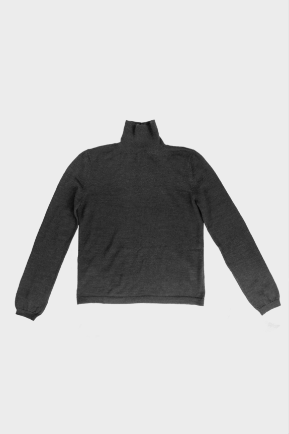 A folded dark gray turtleneck sweater on a plain background.